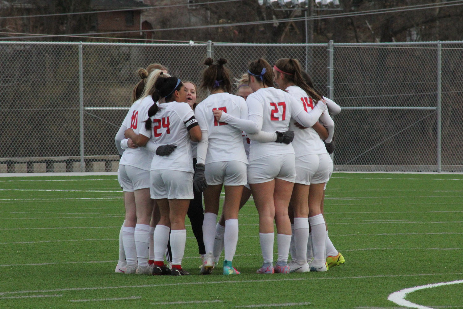The Mexico Lady Bulldogs huddle before their season-opening game on Friday at Jefferson City. They lost 6-0 to the Lady Jays on Jefferson City's new field.