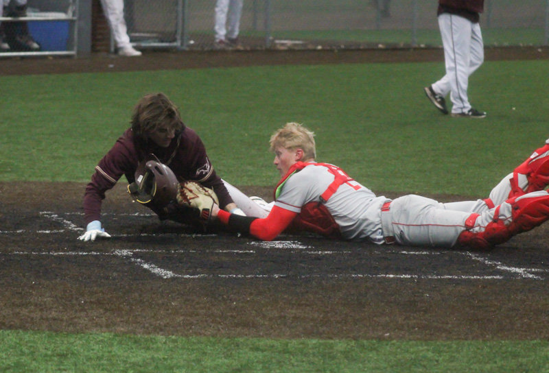 Mexico senior Ty Sims applies the tag to Eldon's Kasen Bashore in the sixth inning of Friday's game in Mexico. The play resulted in an inning-ending out to preserve the Bulldogs' 7-6 win.