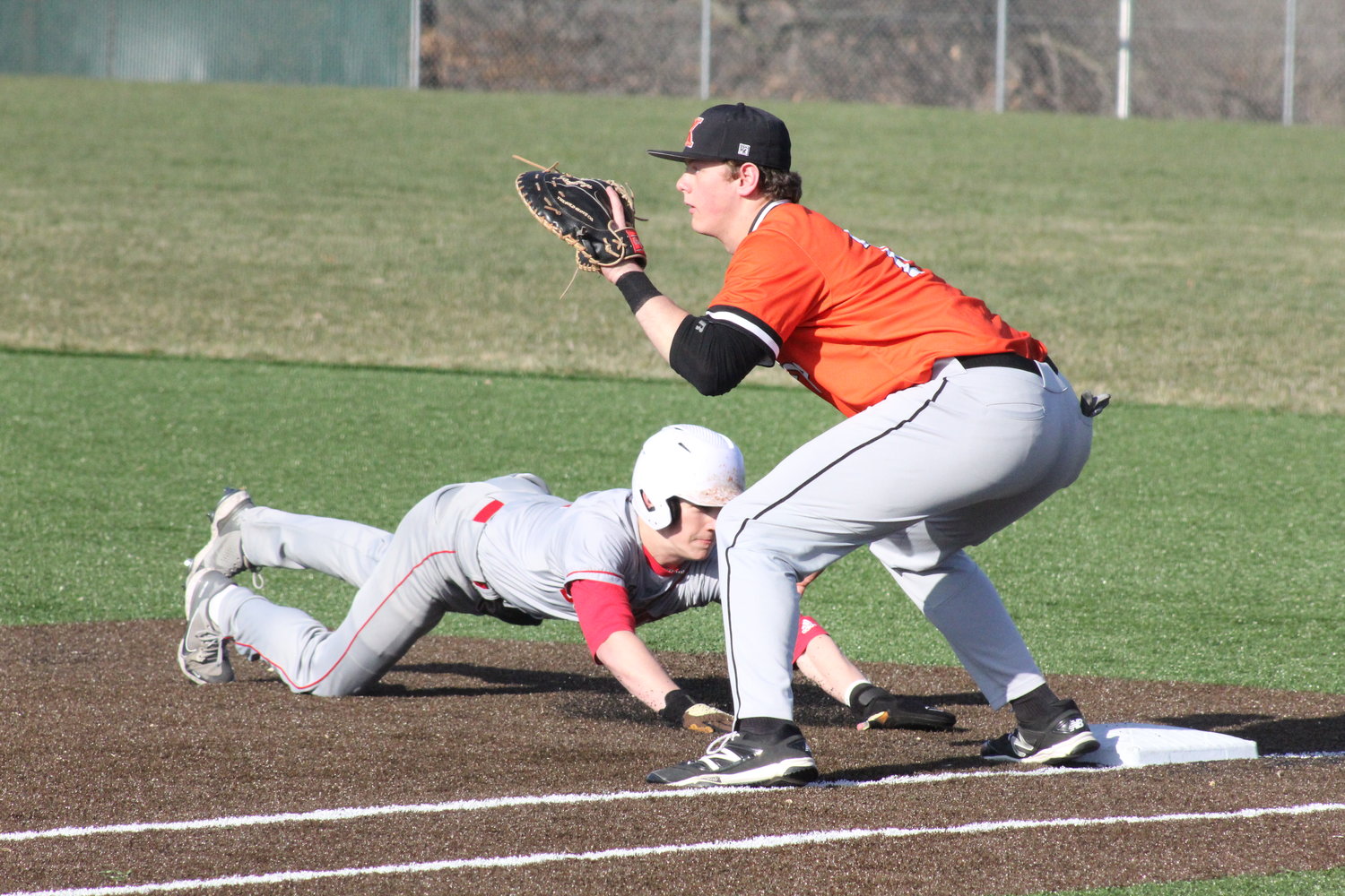 Mexico senior Andrew Runge slides back into first base on a pickoff move by Kirksville on Tuesday in Mexico.