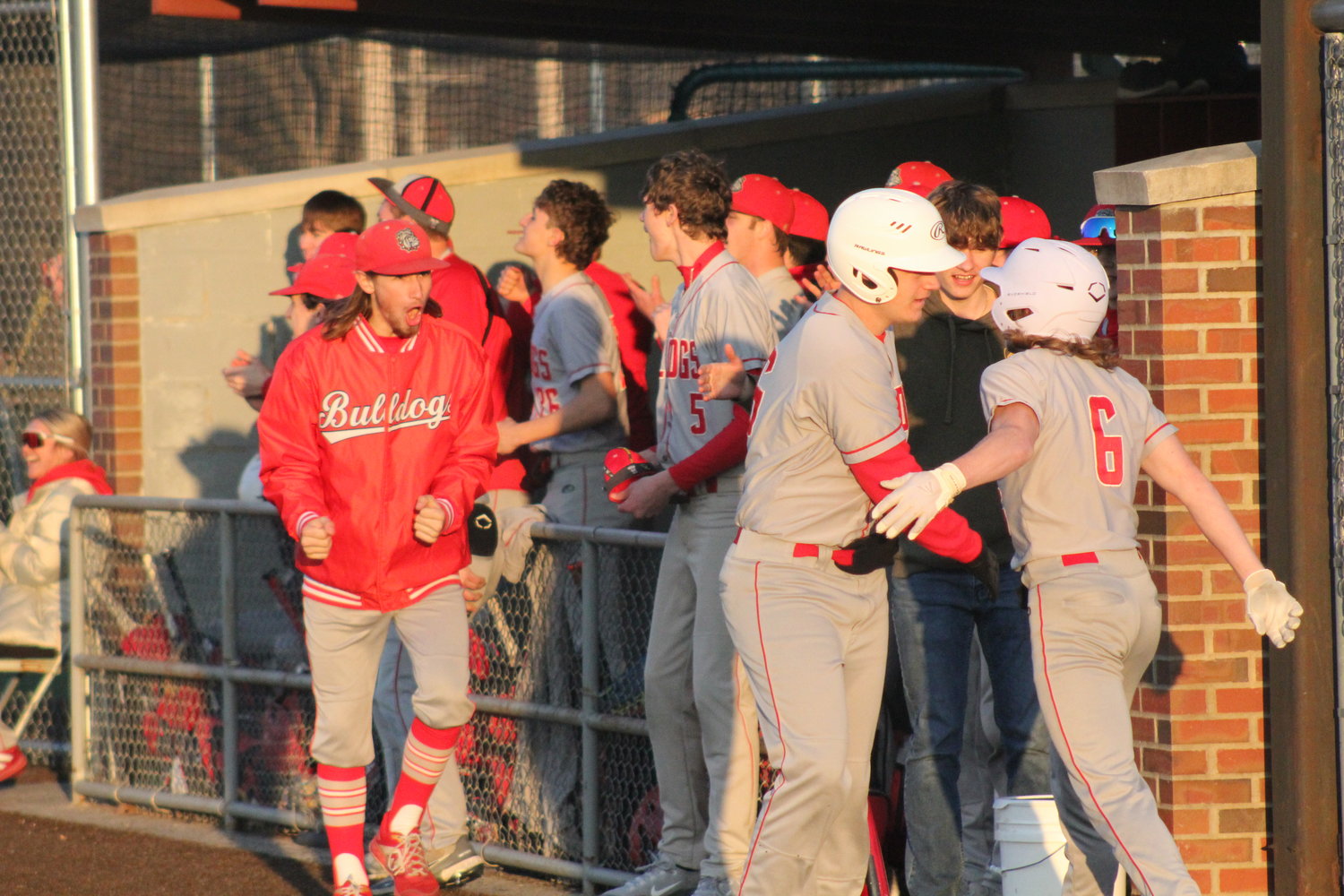 Mexico's dugout celebrates after senior Ty Sims drove in senior Landyn Kleinsorge (6) to tie the game at 7 in the seventh inning against Kirksville on Tuesday in Mexico.