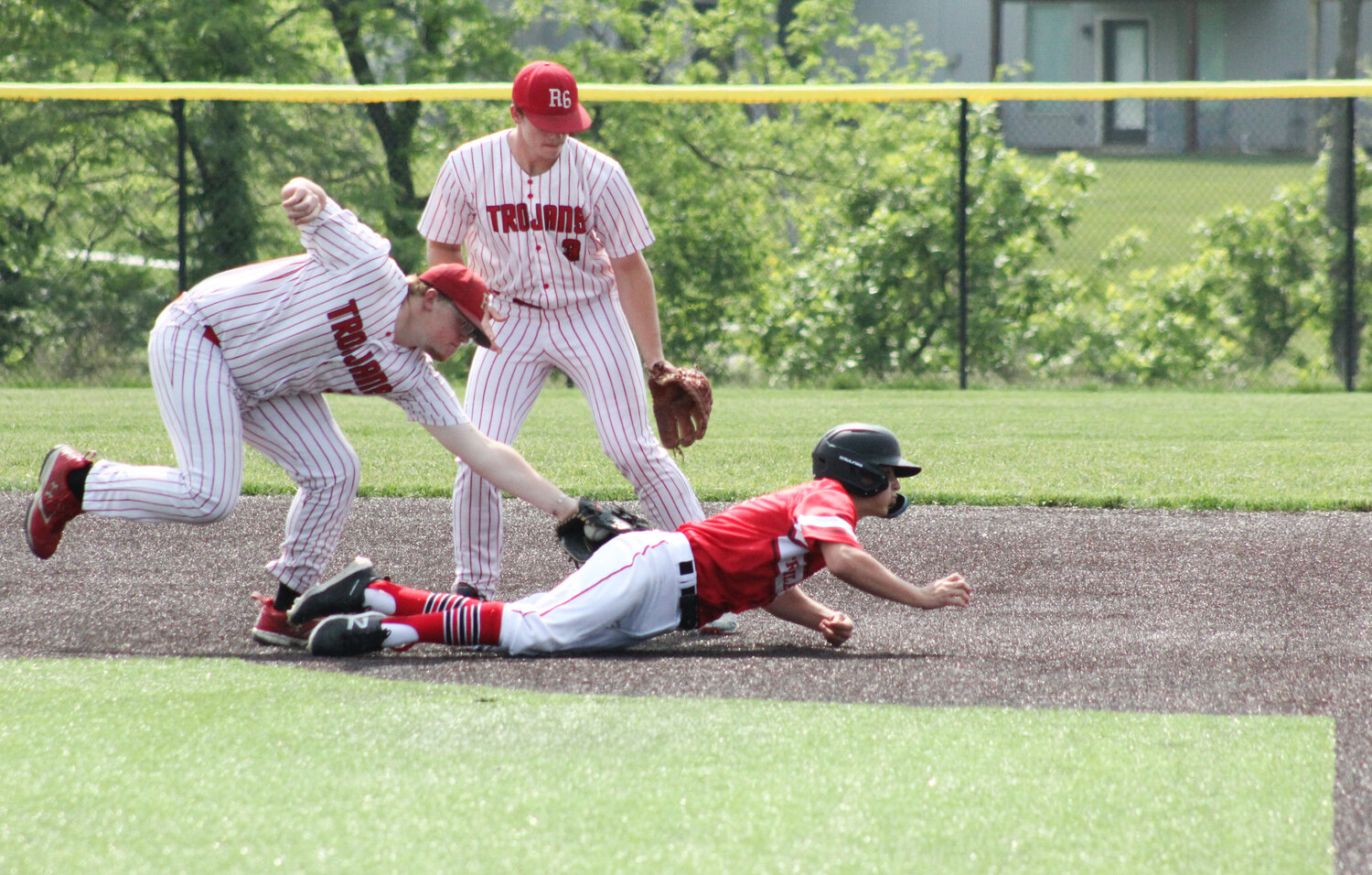 Community R-6 senior Pacey Cope tags out a Northland Christian runner between second and third base in Monday's state playoff game in Parkville.