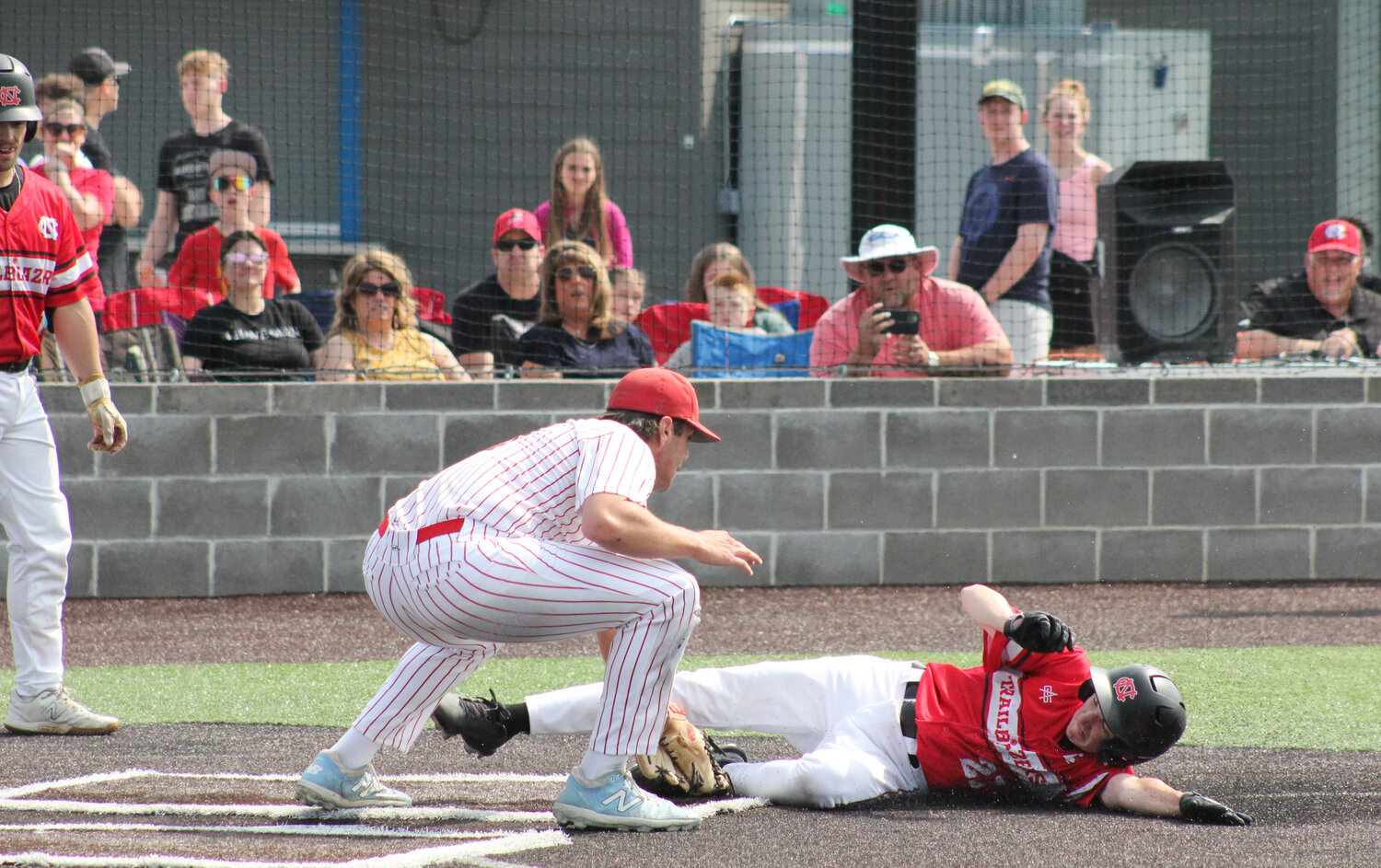 Community R-6 senior pitcher Gavin Allen tags out Northland Christian's Joshua Wolf trying top score on Monday in a state playoff game at Creekside Baseball Complex in Parkville. The Trojans won 5-1 and will host Sacred Heart at 5 p.m. today for a chance to go to the state Final Four.