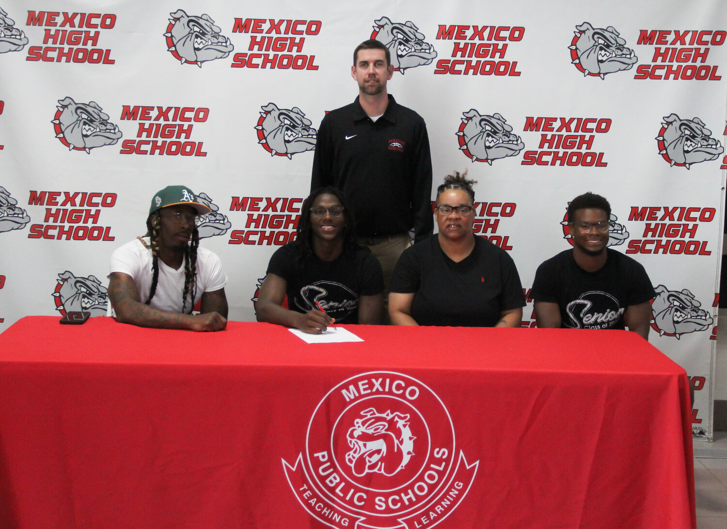 Mexico senior Jordan Shelton made it official on Thursday at the Mexico Sports Complex that he would play college basketball for John Wood Community College in Quincy as he was surrounded by family and his head coach Darren Pappas.