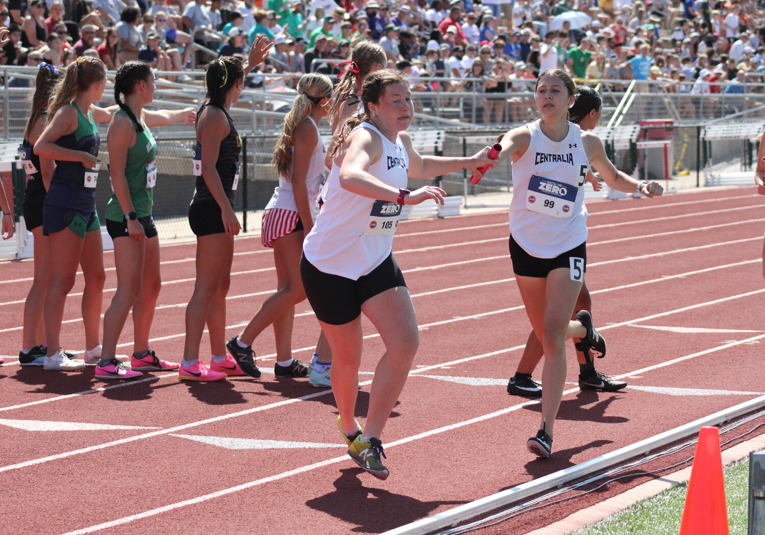 Centralia senior Annie Robinson takes the handoff from freshman Becca Erisman in the girls 4x800 relay on Friday in the Class 3 state track and field meet.