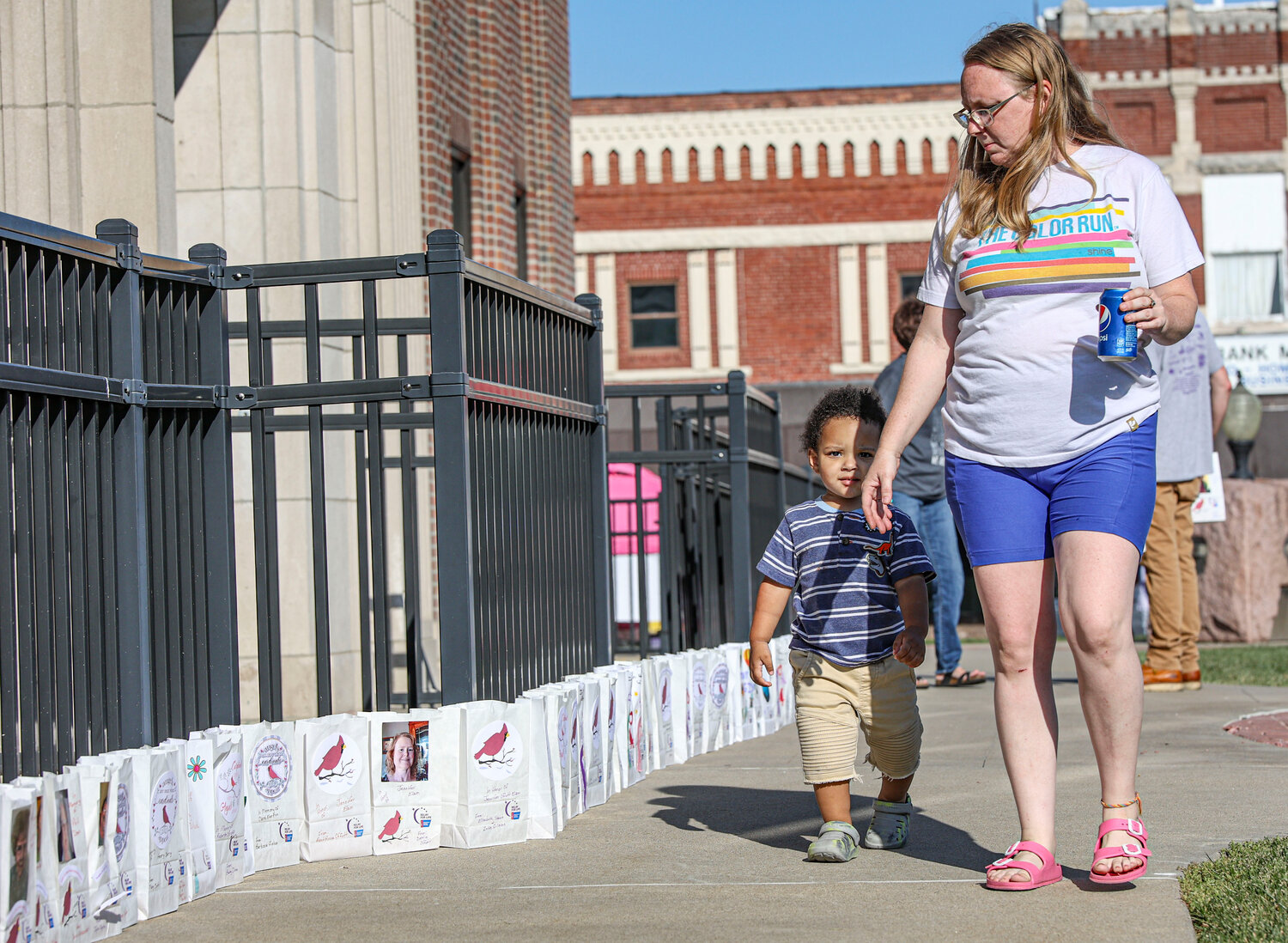 Beth Culwell and her son Audric Shields walked along the remembrances left of those who have passed from cancer at the Relay For Life event on Saturday, Sept. 9, at the Audrain County Courthouse. Culwell and Shields were there to honor Culwell’s mother, Barbara Gregory, who is a survivor.