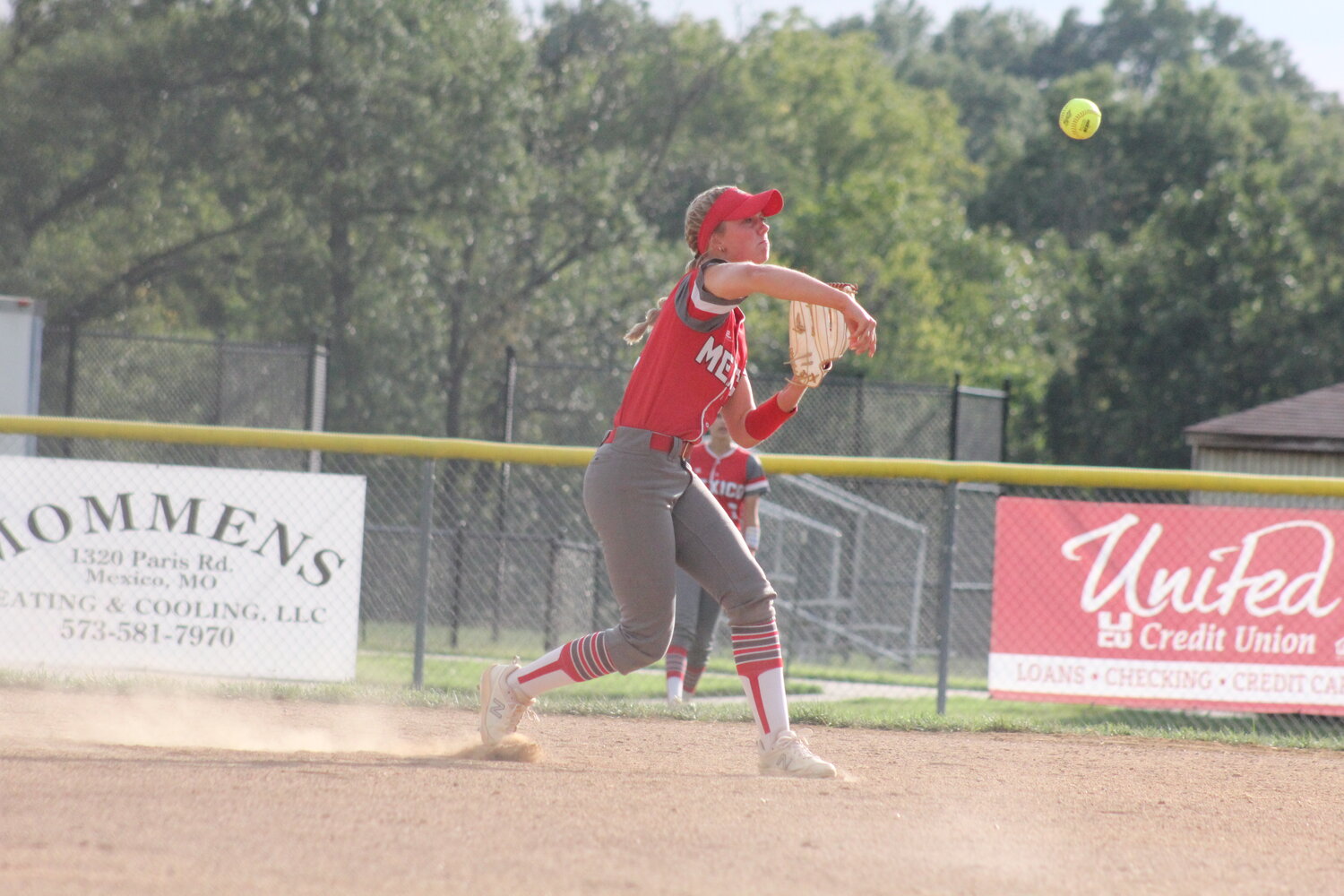 Mexico senior Jo Thurman throws to first base for an out on Thursday at home against Fulton.