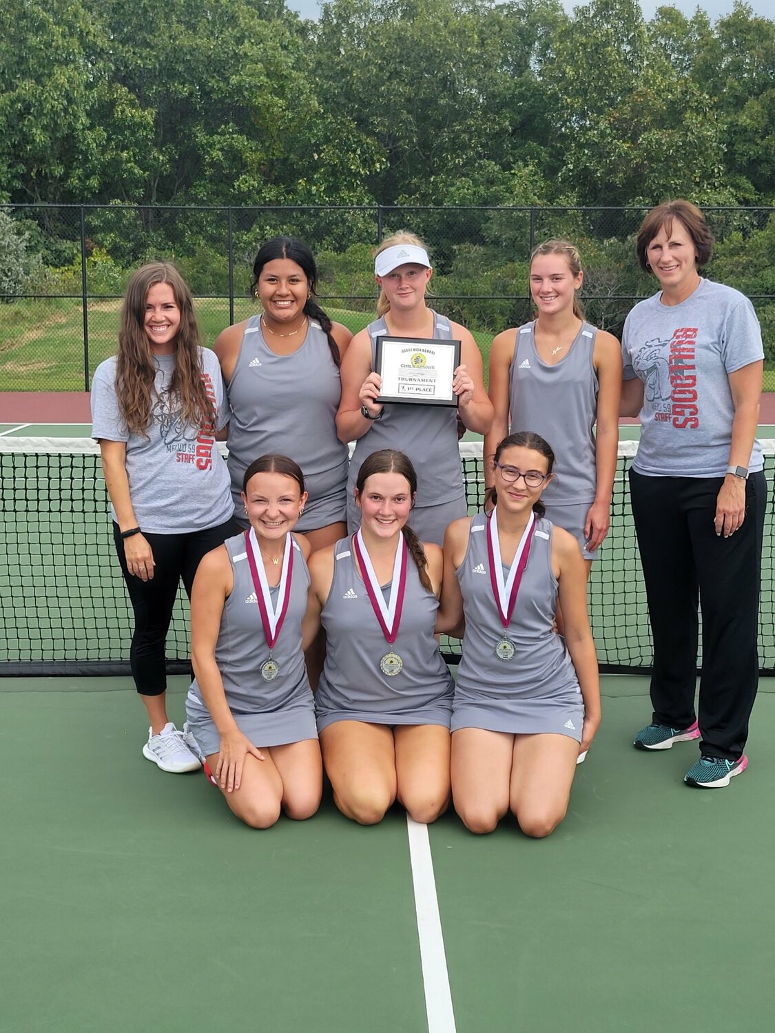 Mexico girls tennis celebrates after winning the Osage Tournament on Saturday. In the front row are the team's medalists, Lani Blair, Katie Gooch and Lucy Gleeson.