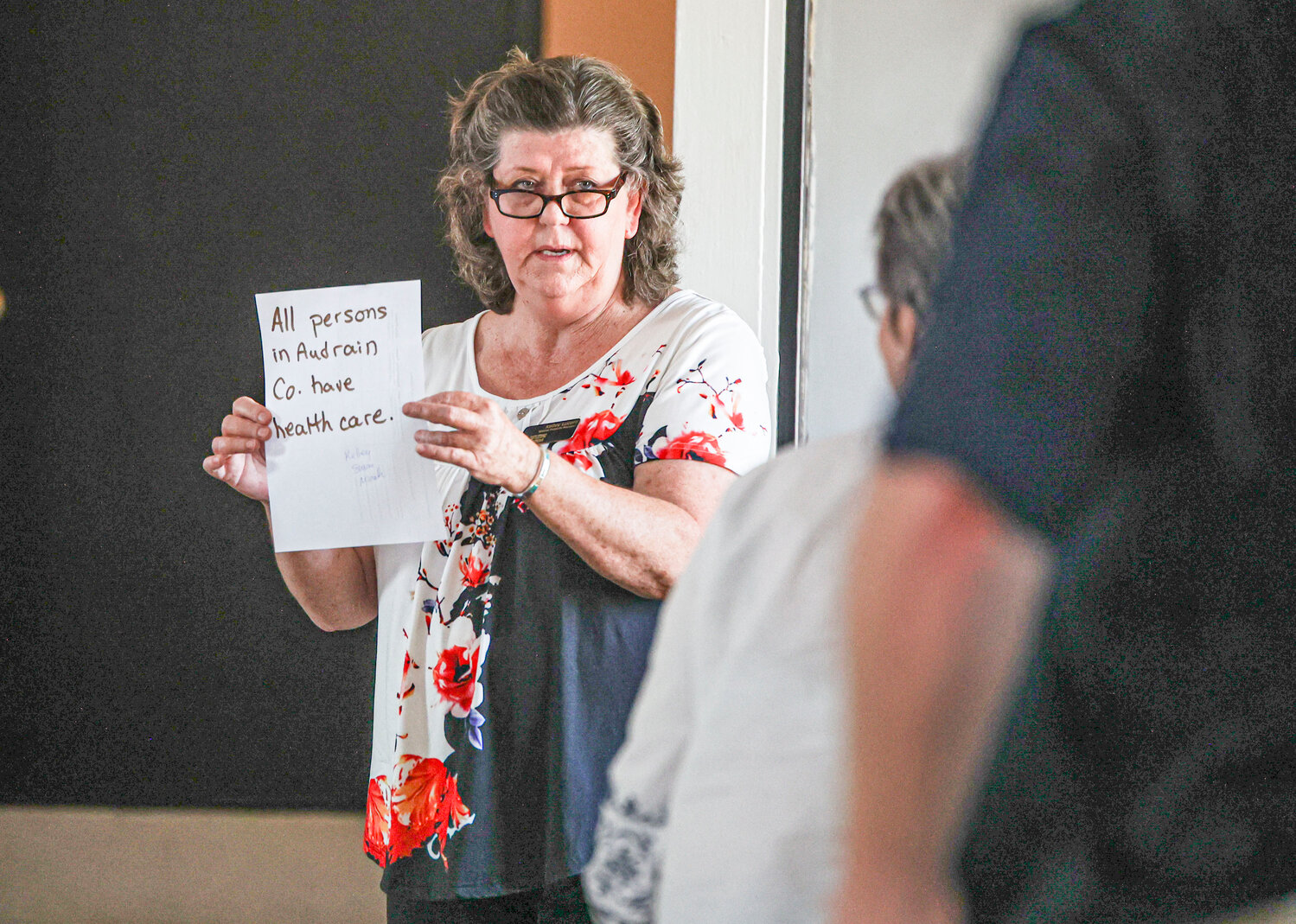 Kelley Lucero with Central Missouri Community Action holds up a note during a meeting in June.