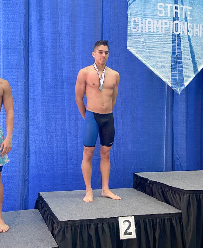Missouri Military Academy junior Tiago Ruas Deluca stands on the podium Friday after winning second place in the 100-yard butterfly at the Class 1 state swimming meet.