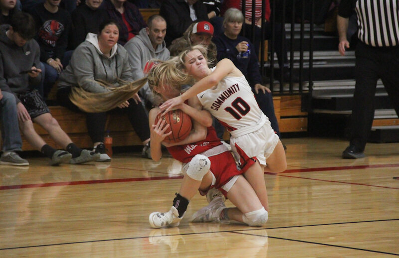 Community R-6 senior Alyssa Beamer fights with Marion County for possession on Tuesday at home.