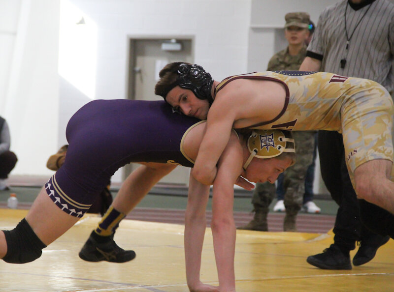 Missouri Military Academy junior Ryan Miles stays on top of his opponent on Saturday at the MMA Colonels Classic in Mexico.