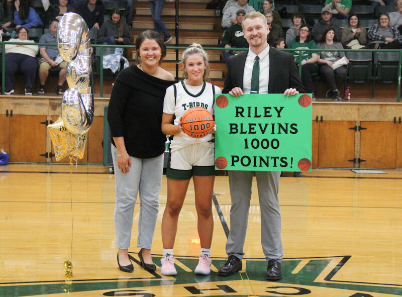 North Callaway senior Riley Blevins is recognized alongside assistant coach, and her sister, Logan Blevins and head coach Andrew Klein after scoring her 1,000th point in the first quarter of the Ladybirds' Senior Night win on Monday against Wright City in Kingdom City.