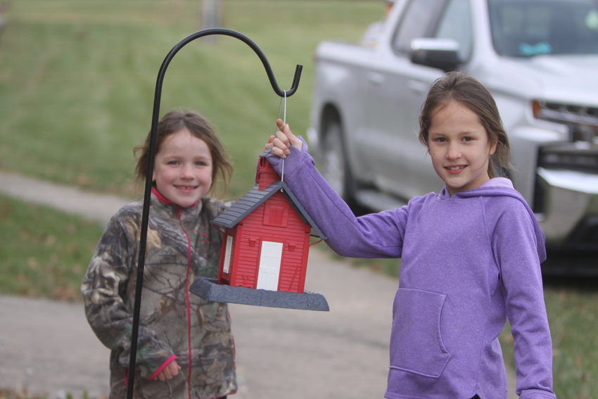 Sisters Lila and Quinn Cope pose with a bird feeder at St. Andrew&rsquo;s in New Florence on Nov. 14. A total of 19 bird feeders were installed at the St. Andrew&rsquo;s facility.