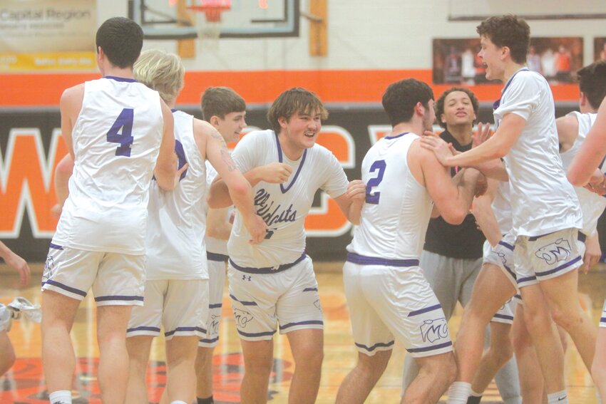 The Montgomery County boys basketball team celebrates after beating Hermann in the Class 3, District 7 title game on Feb. 24 en route to a 25-7 record and a fourth-place finish at the state tournament.