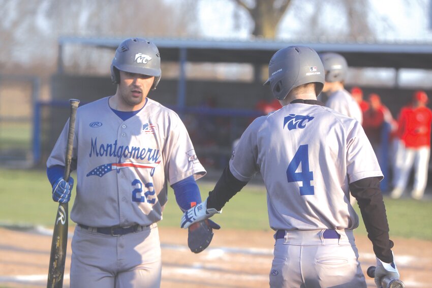 Montgomery County senior Jace Ellis is congratulated by senior Bryson Hoffmann after scoring a run in the Wildcats’ home opener against Linn on March 21.