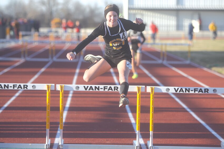 Wellsville-Middletown senior Bethany Slovensky approaches the finish line at the 300-meter hurdles at the Van-Far Open Meet on March 18. Slovensky, who has earned seven all-state medals, is one of several returners on this year’s W-M team.