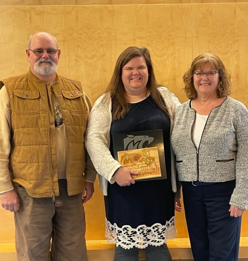 Montgomery County High School agriculture teacher Mary Leykamp poses with her R-II Teacher of the Year award and her parents.