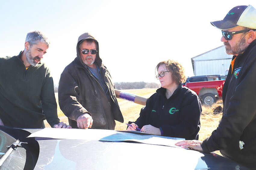 David Bunge, left, of Azurite Solar, LLC, met recently with Montgomery County Planning and Zoning member Roy Cope, Planning and Zoning administrator Donna Viehmann and University of Missouri agronomist Rusty Lee. Azurite presented its site plan for a proposed solar farm at Tree Farm Road in New Florence, just south of Interstate 70.