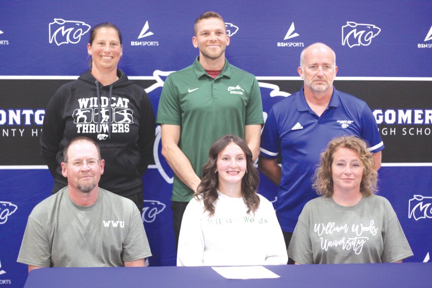 Montgomery County senior El Reagan signs a letter of intent to compete in track and field at William Woods University for the 2024-25 school year on April 11 at the MCHS gymnasium. Pictured, front row from left, are father Russ Reagan, El Reagan and mother Candi Reagan. Back row are MCHS track coach Stephanie Finke, William Woods coach Dan Schwab and MCHS assistant track coach Nathan Thurman.