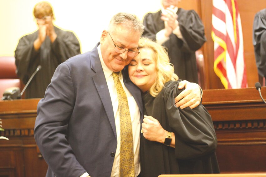 Missouri Supreme Court judge and Montgomery City resident Kelly Broniec gets a hug from friend Jeff Arens during her investiture ceremony on April 15 at the Missouri Supreme Court in Jefferson City.