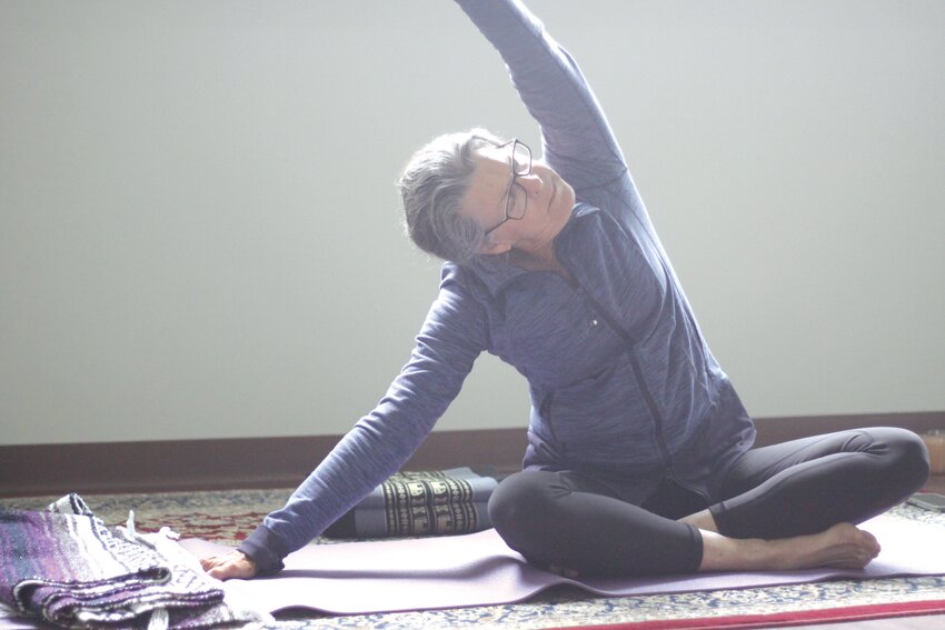Pat Turner demonstrates a yoga lesson during a class on April 25 at Balasana Yoga Studio in Jonesburg. Turner is the owner of the yoga studio, which is celebrating 10 years in business.