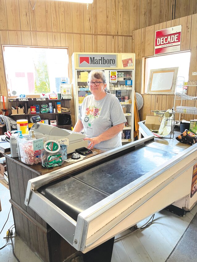 Terri Thomas, owner of Middletown Country Store, stands behind the sole checkout counter in the store.