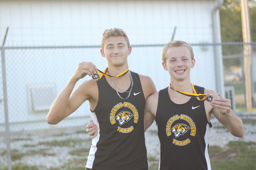 Wellsville-Middletown seniors Gage Marshall and Jonah Slovensky pose with their medals at the Wellsville-Middletown Invitational on Sept. 25. They’re the only seniors on the W-M cross country team.