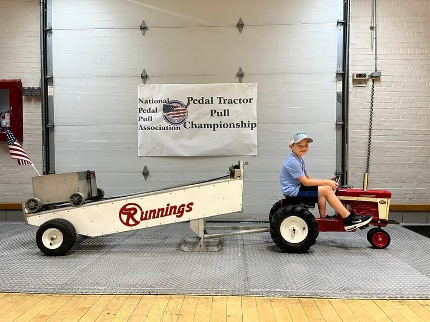 Montgomery City resident Maverick Van Horn poses with his tractor at the National Kids Pedal Pull Championships in Mitchell, S.D. The 6-year-old placed in the top 10.