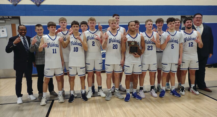 The Montgomery County boys basketball team poses with its district championship plaque after beating Hermann 58-41 in the Class 3, District 7 championship game on Friday at South Callaway High School.