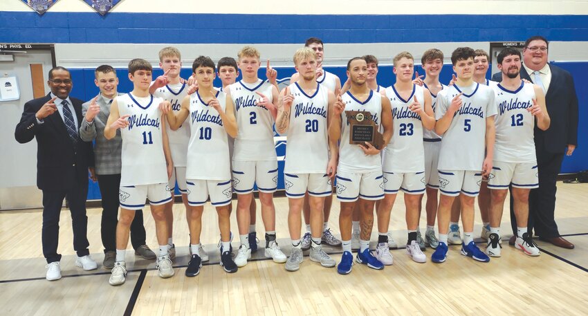 The Montgomery County boys basketball team poses with its district championship plaque after beating Hermann 58-41 in the Class 3, District 7 championship game on Friday at South Callaway High School.