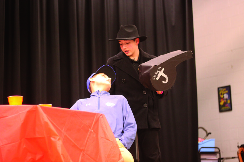Montgomery County Middle School seventh-grade students Brady Falloon and Ethan Hogue do their performances at the FCCLA Murder Mystery Dinner on March 1. Brady played Coach J and Ethan played the detective.