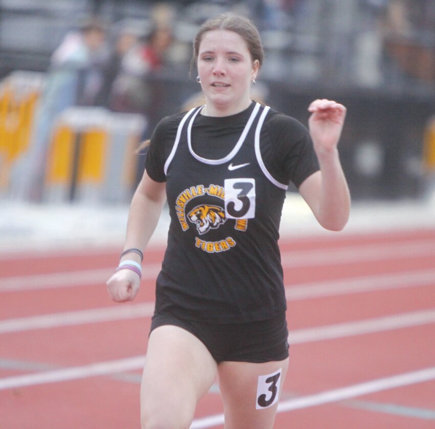 Wellsville-Middletown sophomore Elly Cash approaches the finish line in the 200-meter dash at the Van-Far Open Meet on March 24.