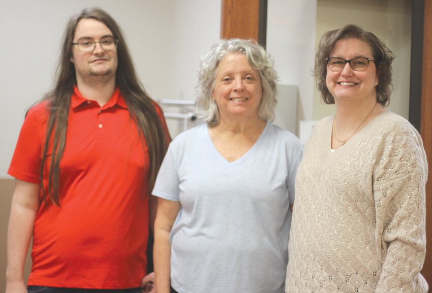 Volunteer Carole Harness poses with Montgomery City Public Library employee Brian Sippel and director Gaylee Harris on April 5. Harness has retired as a volunteer of the library’s robotics program after 10 years.