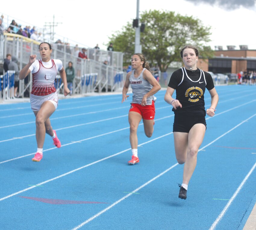 Wellsville-Middletown sophomore Elly Cash, right, competes in the 100-meter dash at the Eastern Missouri Conference championship meet on May 2 at Montgomery County High School. Cash was one of the Tigers’ top performers at the EMO meet, placing second in the 100 and 200.