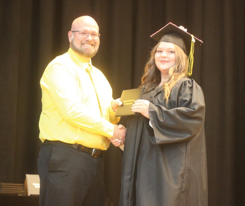 Karley Jo Arens poses with her diploma with Wellsville-Middletown High School principal Kevin Oligschlaeger during the graduation ceremony on May 9.