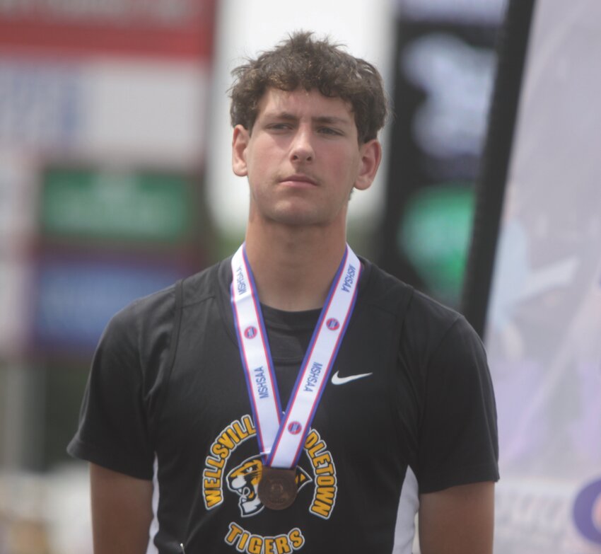 Wellsville-Middletown senior Cooper Henderson poses with his sixth-place medal in the 110-meter hurdles at the Class 1 state meet on May 24 in Jefferson City.