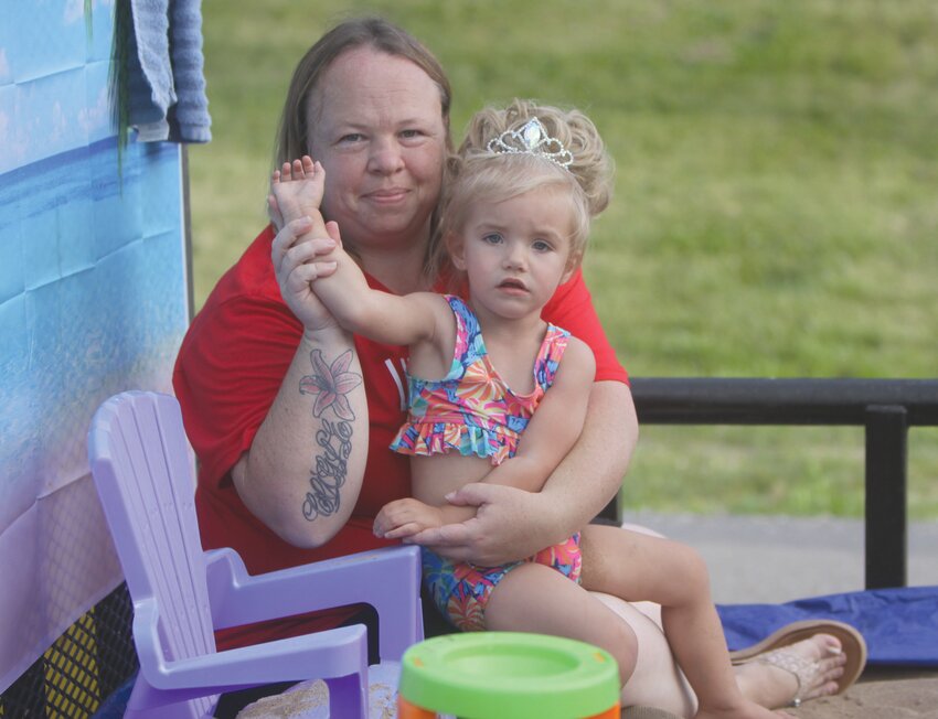 Tina and Olivia Cagle of Bellflower wave to the crowd during last year’s Jonesburg Homecoming Parade. The 83rd annual event returns on June 12.