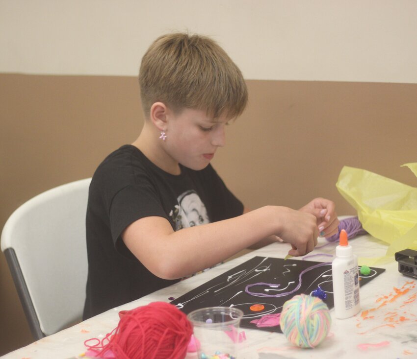 Alva Powell works on her Starry Night piece at the Montgomery City Public Library Pastiche Night program.