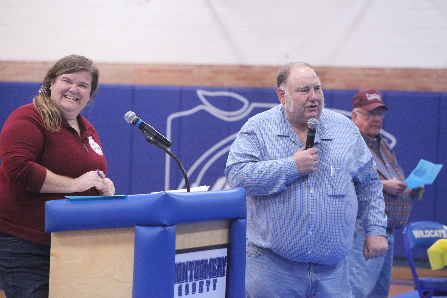 Charlie Korman (right) performs his duties as the auctioneer of the Montgomery County High School FFA Labor Auction on Nov. 18. On the left is FFA co-advisor Mary Leykamp.