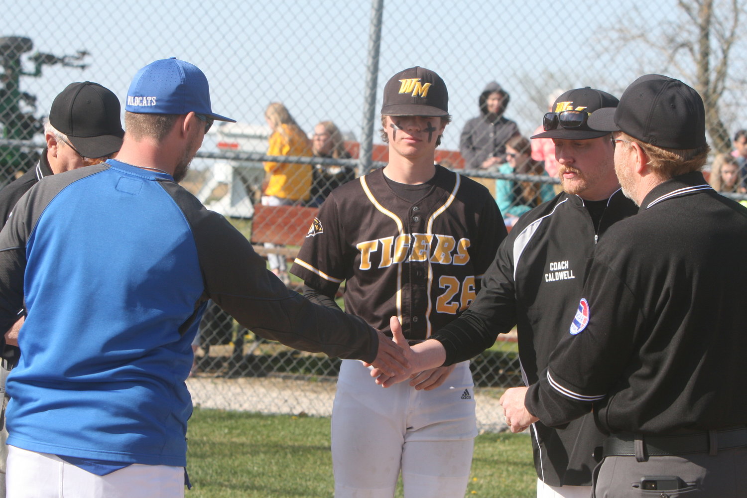Montgomery County coach Vince Wolk shakes hands with Wellsville-Middletown coach Justin Caldwell before the Wildcats-Tigers game on April 26. W-M starts its district play on May 12, while MCHS begins its district action on May 16.