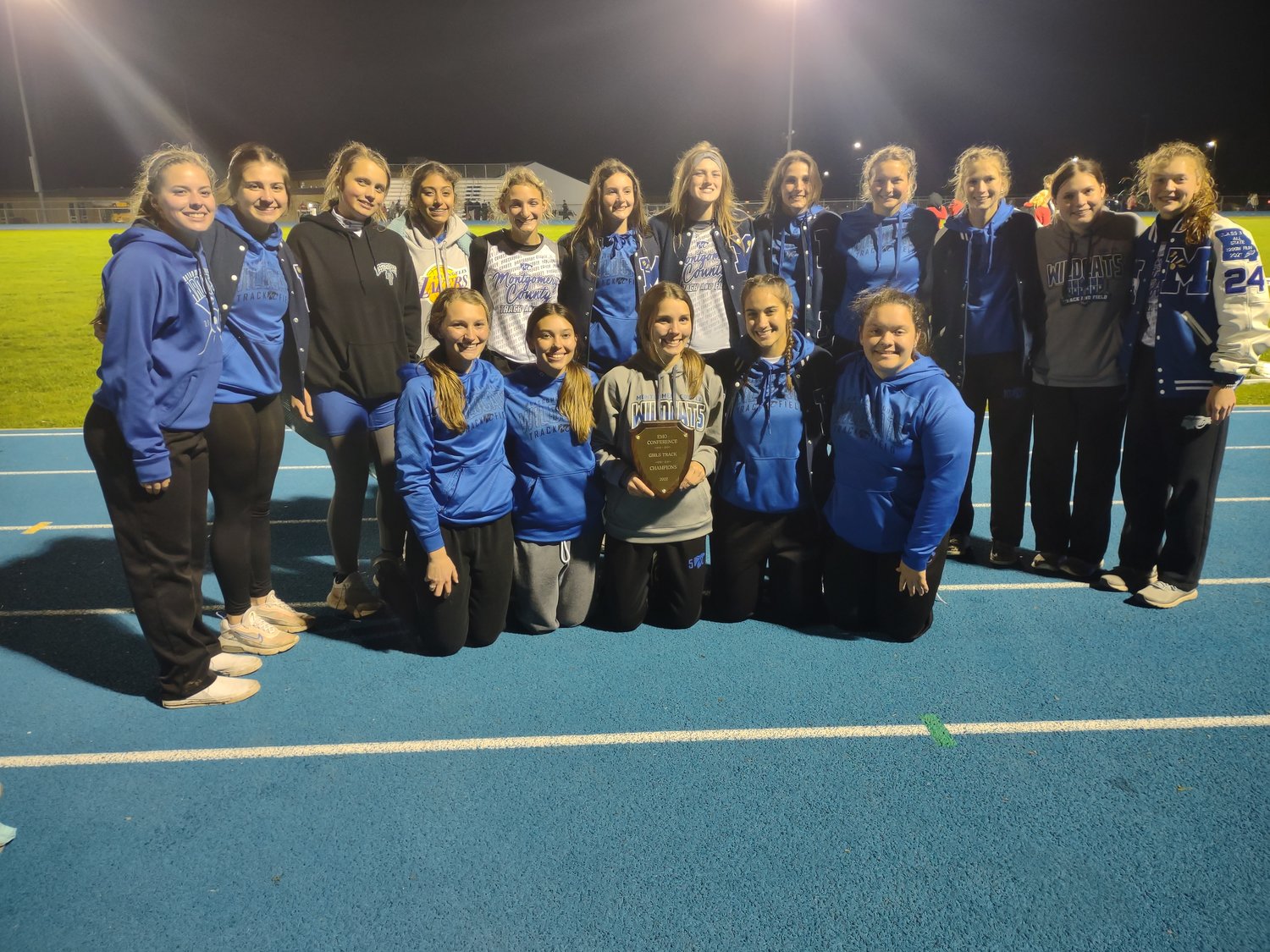 The Montgomery County girls track team poses with its Eastern Missouri Conference championship plaque after winning the 11-team conference meet with 188.5 points on May 3 at Jim Blacklock Field.
