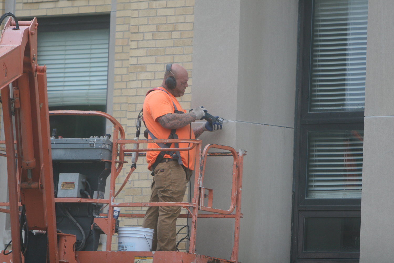 Johnny Mitchel of Staat Tuckpointing and Waterproofing applies caulk to the Montgomery County Courthouse building on June 8.