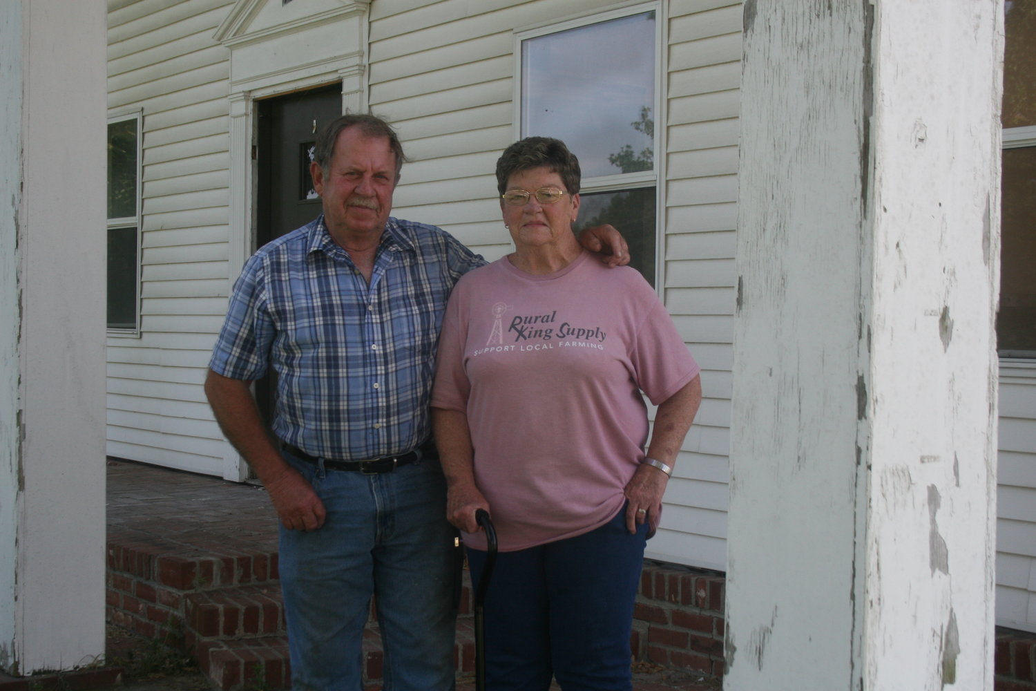 Montgomery City residents David and Mary Falloon pose in front of their old home at 901 Pickering Street, which will be torn down later this summer. The house was built in 1875.