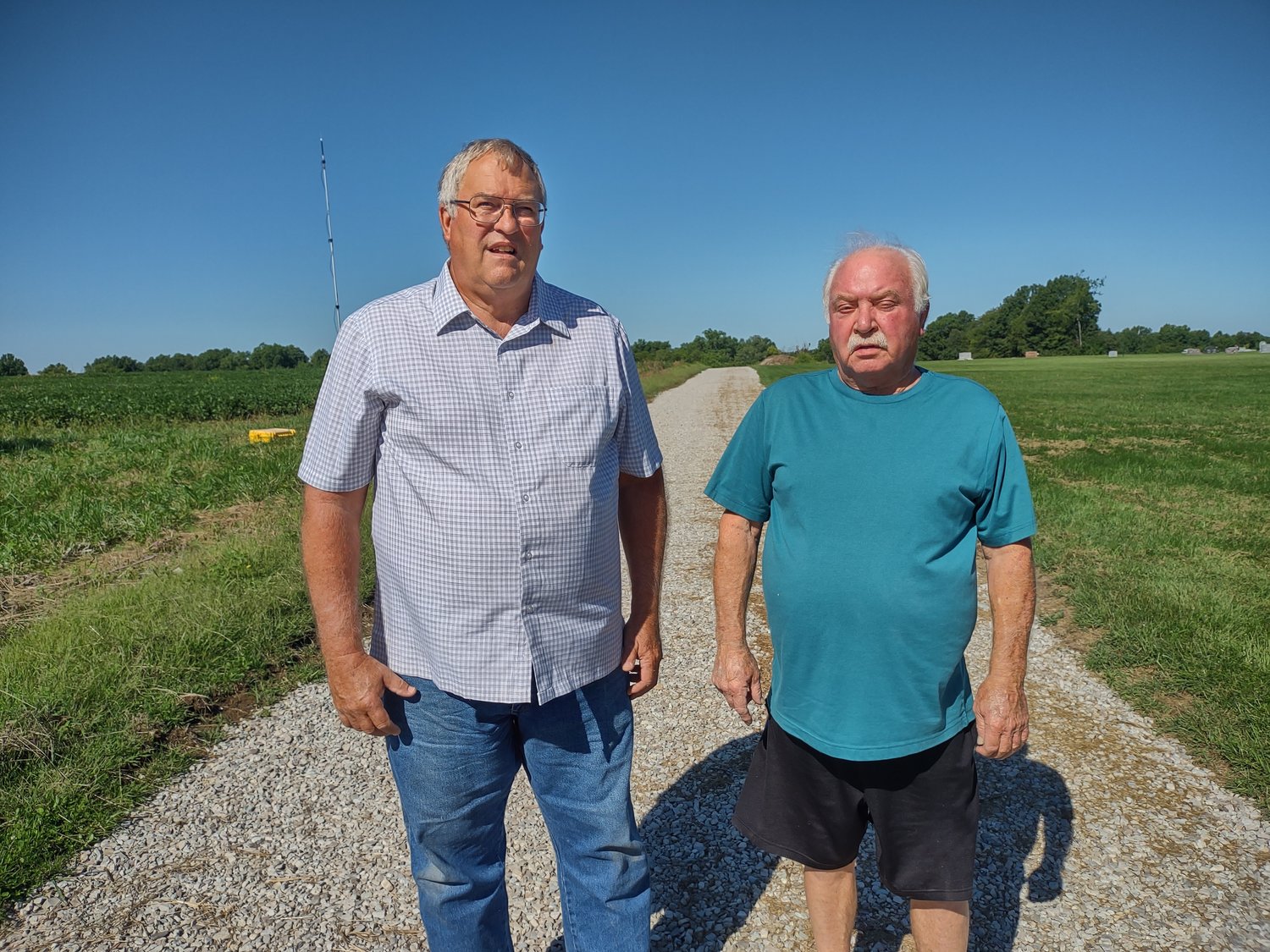 Larry Elflein and Ralph Young of the New Florence Cemetery Board pose at the new south road near the cemetery that was constructed by Glenn Bartlett Trucking and Excavating in August.