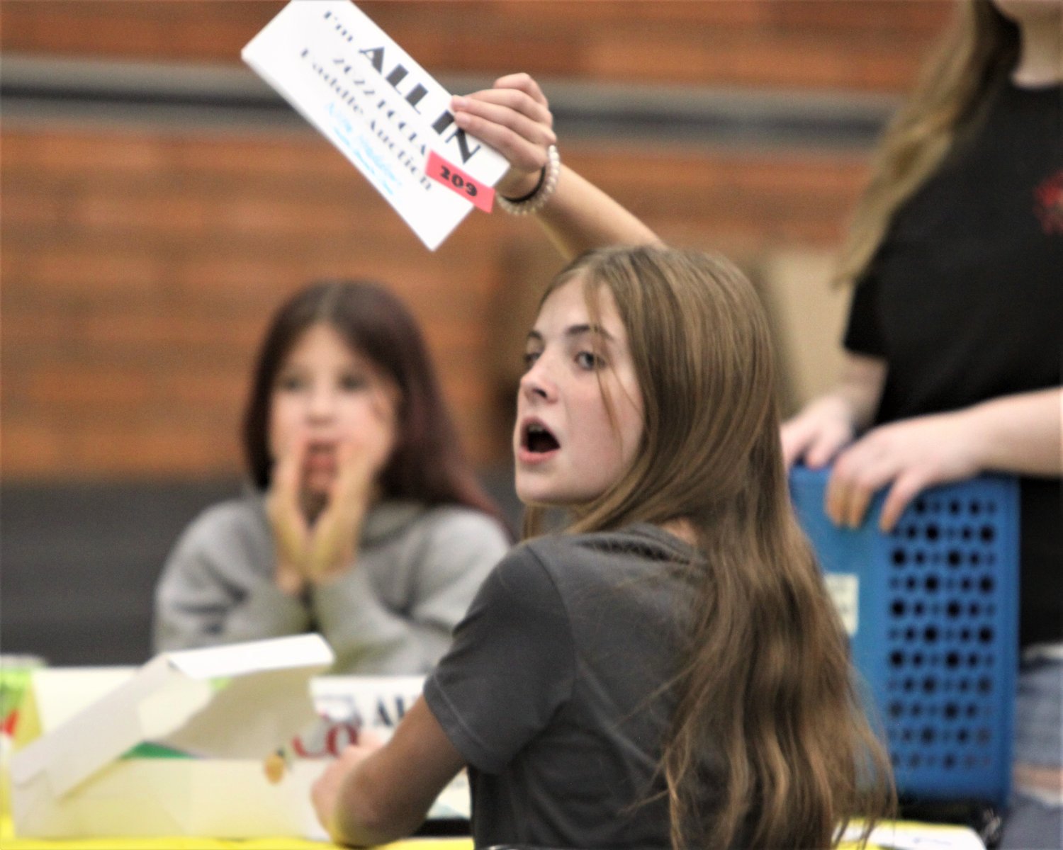 Harper Monsen of Montgomery City shows her all-in paddle during the Ninth Annual FCCLA Paddle Auction on Nov. 5 at the Montgomery County Middle School multipurpose room.