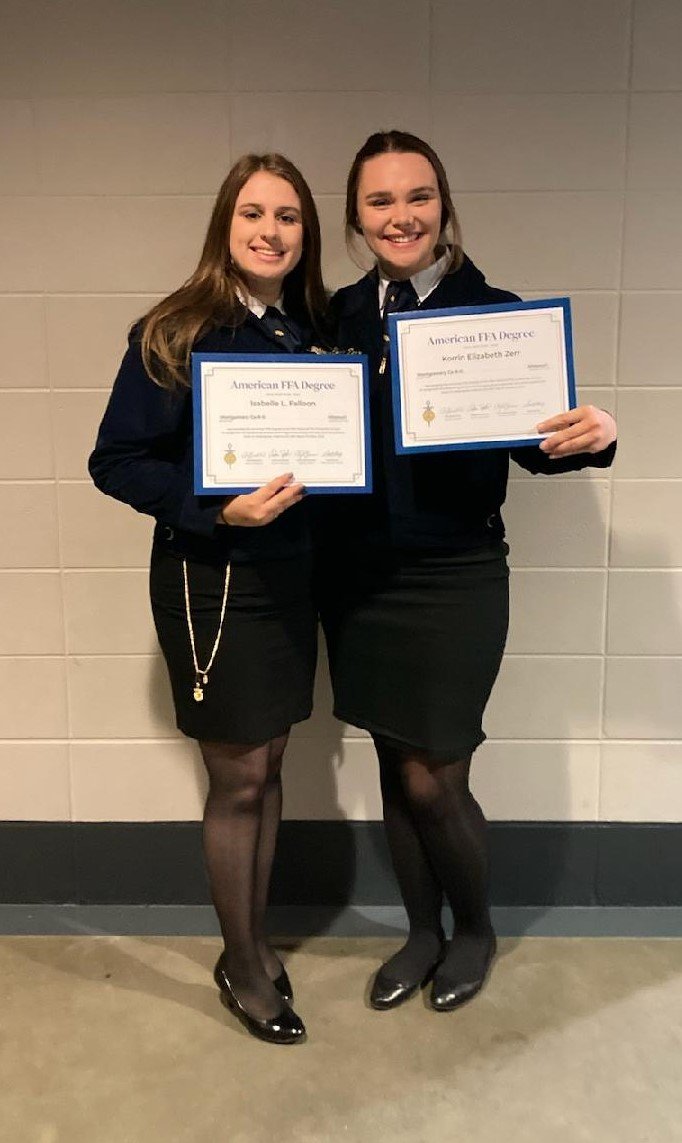Montgomery County graduates Izzy Foster and Korrin Zerr pose with their American FFA Degrees at the FFA National Convention on Oct. 29 in Indianapolis. Not pictured is Alison Viehmann.