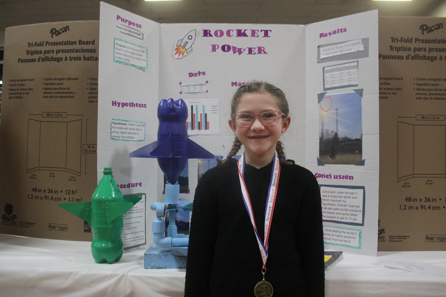 Montgomery City Elementary third-grader Eliza Matthews poses with her first-place science project at the Montgomery County R-II Science Fair on Jan. 12 at MCE.