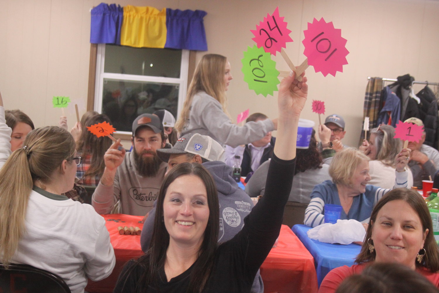 Amanda Owens holds up her paddles during the Montgomery City Lions Club Paddle Auction on Jan. 21.