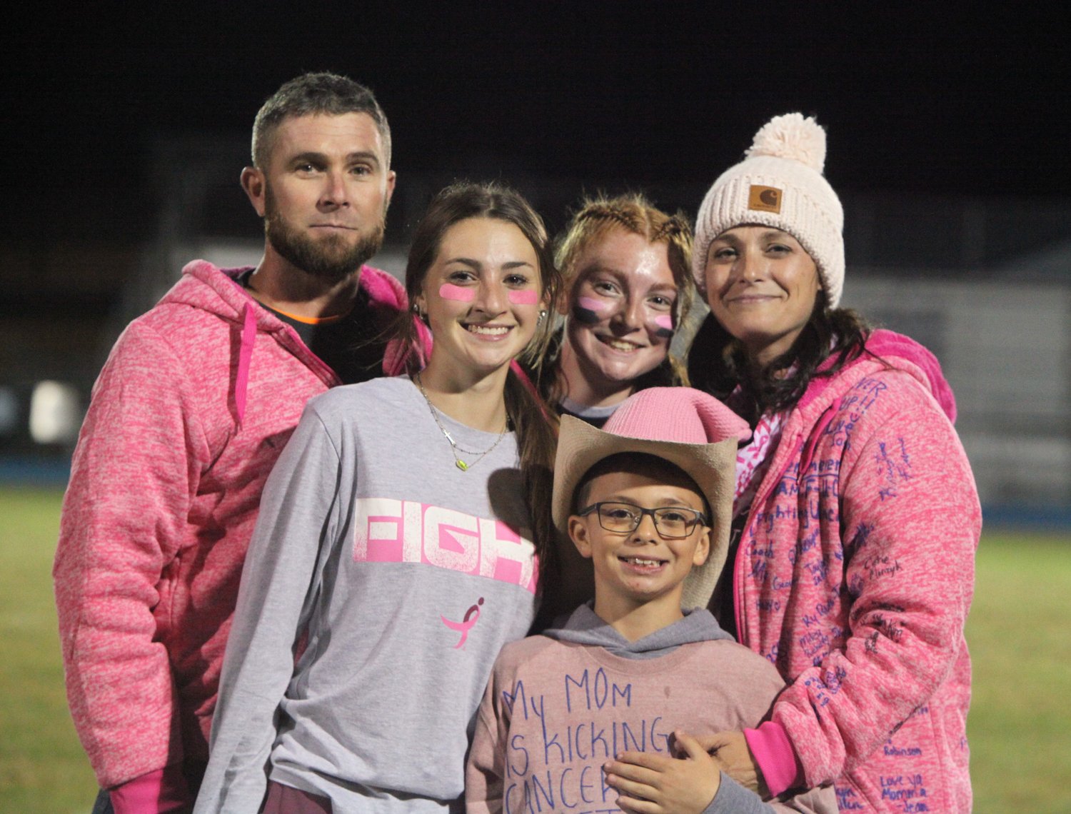 High Hill resident Jessica Eversmeyer, right, poses with her family that includes her husband, Josh, and children, Destani, Josy and William, during the Montgomery County High Powderpuff Football Game on Sept. 28 at Jim Blacklock Field. Eversmeyer is battling stage 4 breast cancer.