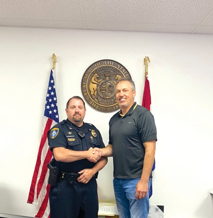 Jason Luna poses with Montgomery City Administrator Steve Deves after being appointed the new Montgomery City police chief during the city council meeting on May 15. Luna has been working at the MCPD since September 1998.